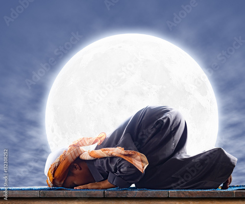 Vászonkép muslim child worshiped Praying for Allah, muslim God, prostrate