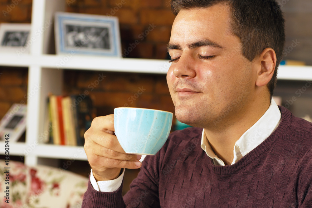 Young man enjoying with closed eyes drink coffee, tea or chocolate. Young man enjoying with closed eyes drink coffee, tea or chocolate.