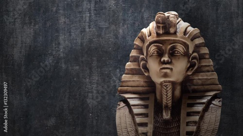 Stone pharaoh tutankhamen mask on dark background