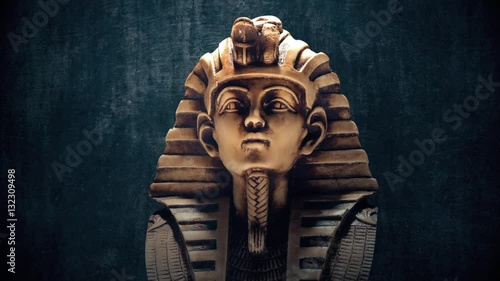 Stone pharaoh tutankhamen mask on dark background photo