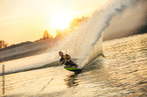 Tableau sur toile Man wakeboarding on a lake
