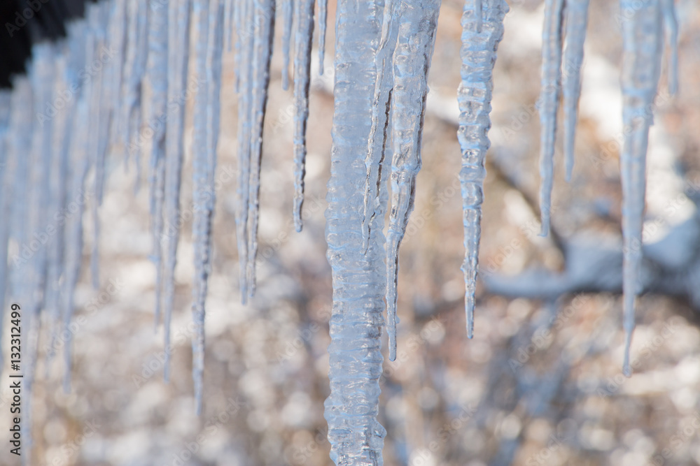 Snowy ice Icicles hanging on a roof house Snowy ice Icicles hanging on a roof house