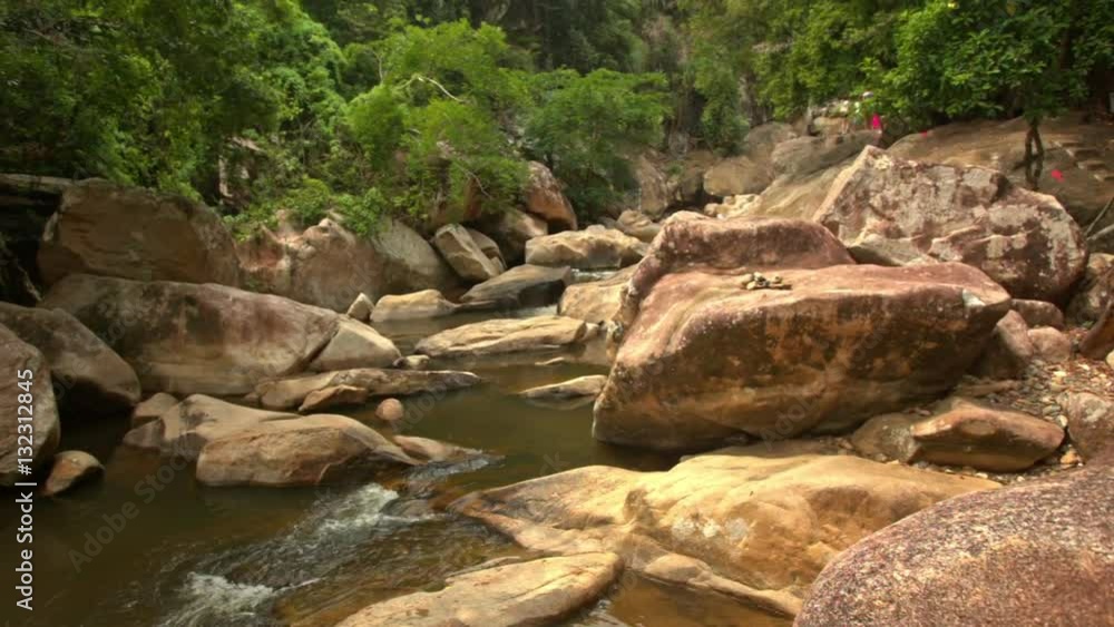 Conglomeration of Large Brown Boulders by River in Park Conglomeration of Large Brown Boulders by River in Park