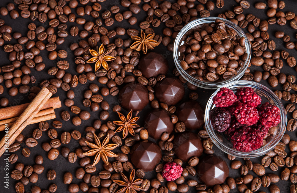 Chocolate sweets, coffee beans, dry raspberries background