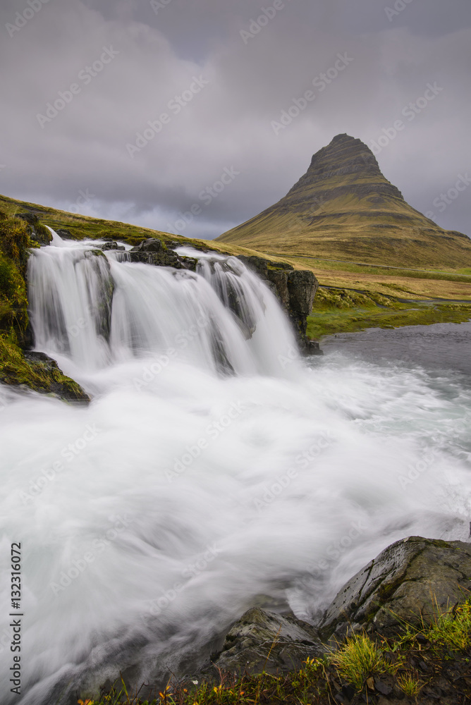 Rushing glacial run-off feeds Kirkjufellfoss on the Snaefellsness Peninsula, Iceland Rushing glacial run-off feeds Kirkjufellfoss on the Snaefellsness Peninsula, Iceland