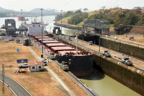 Electric mules guiding Panamax ship through Miraflores Locks on the Panama Canal, Panama photo