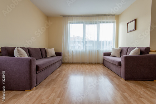 living room with a sofa, windows and curtains - copy space © diyanadimitrova