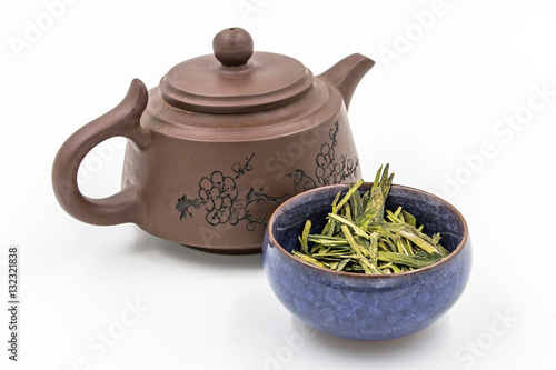Longjing green tea (Dragon Well tea) - Chinese green tea with small clay pot isolated on white.