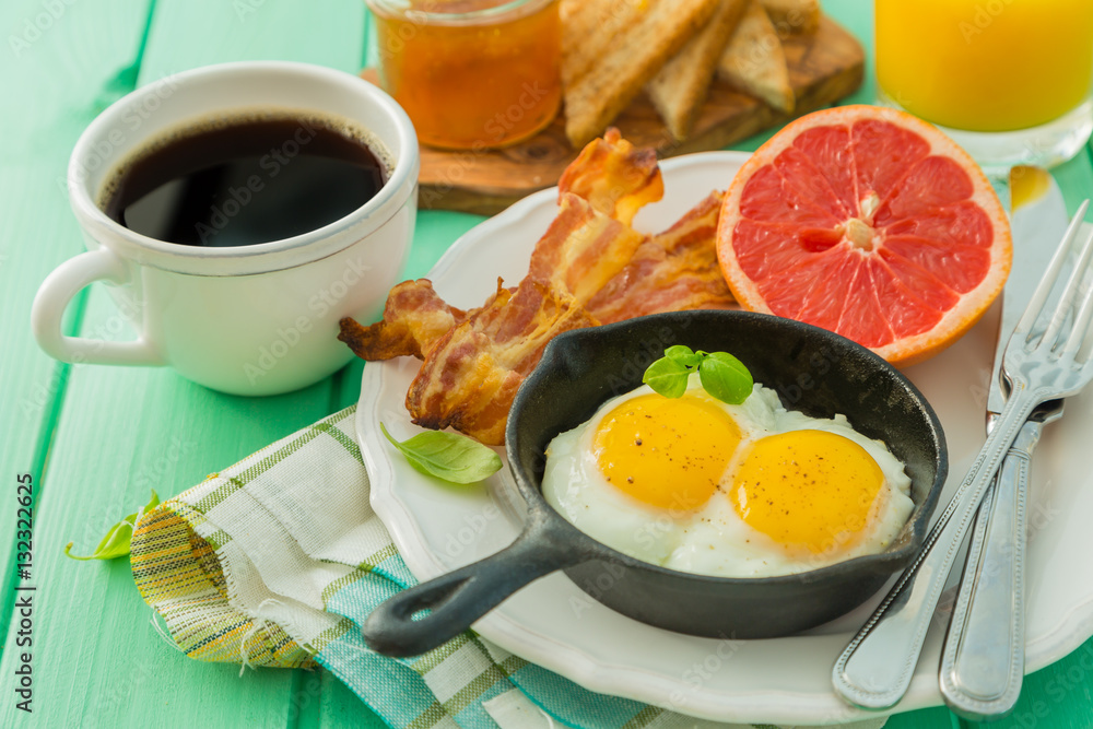 Summer breakfast - eggs, bacon, toast, jam, coffee, juice Summer breakfast - eggs, bacon, toast, jam, coffee, juice