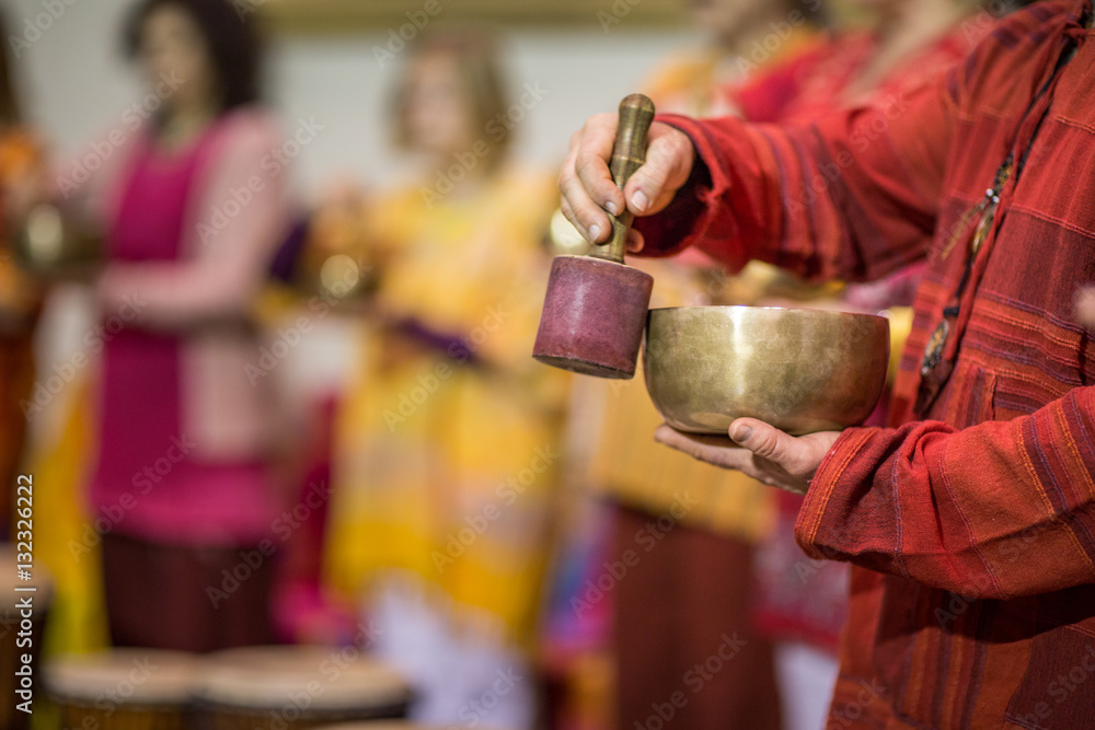 Man playing on a tibetian singing bowl