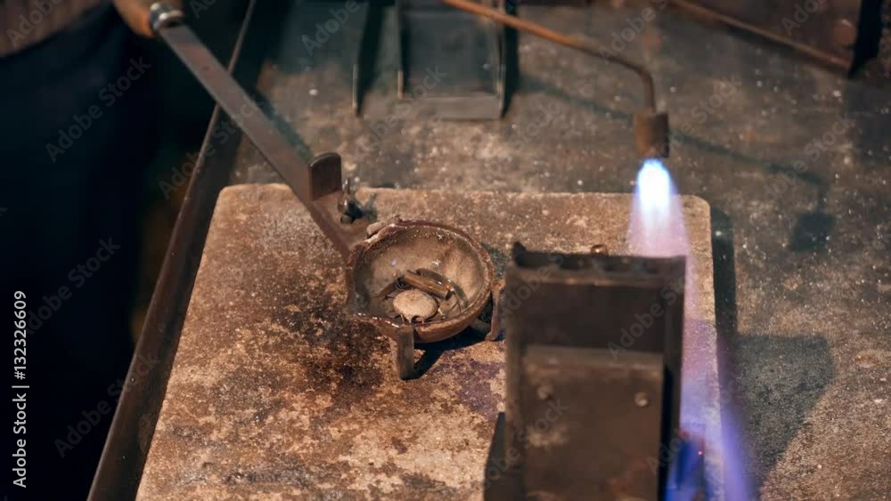 Goldsmith preparing tools for melting gold Goldsmith preparing tools for melting gold