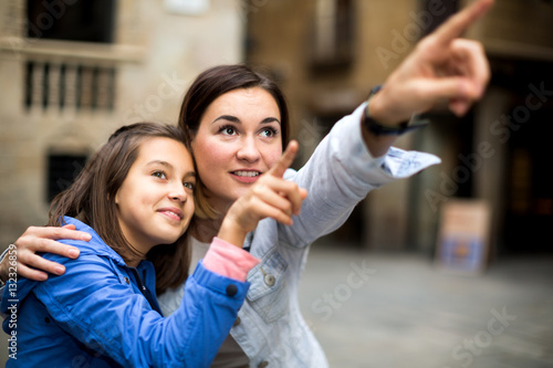 Mother and daughter pointing at sight during
