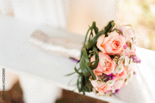 wedding bouquet on kissing newlyweds