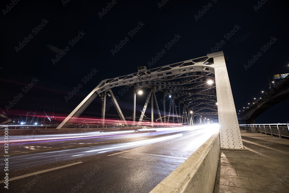 Long exposure image of steel bridge with cars movement.