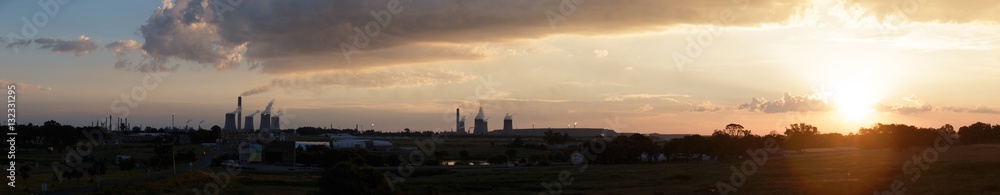 Lens flare sunset Industrial skyline of cement chimneys constant