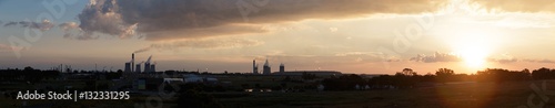 Lens flare sunset Industrial skyline of cement chimneys constant © SphaeraDesigns