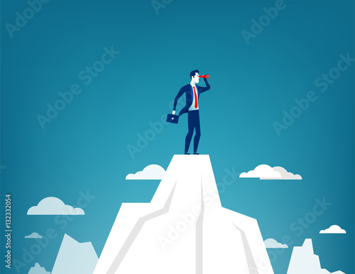 Businessman standing on top of the mountain
