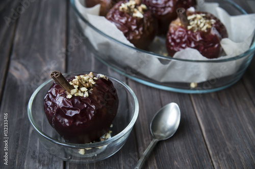 healthy snack in the form of baked red apples with cinnamon and nuts