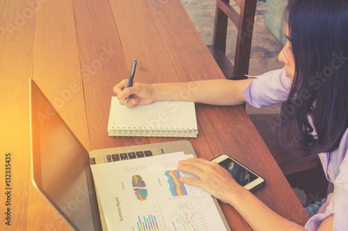 business woman analyzing company annual financial report balance