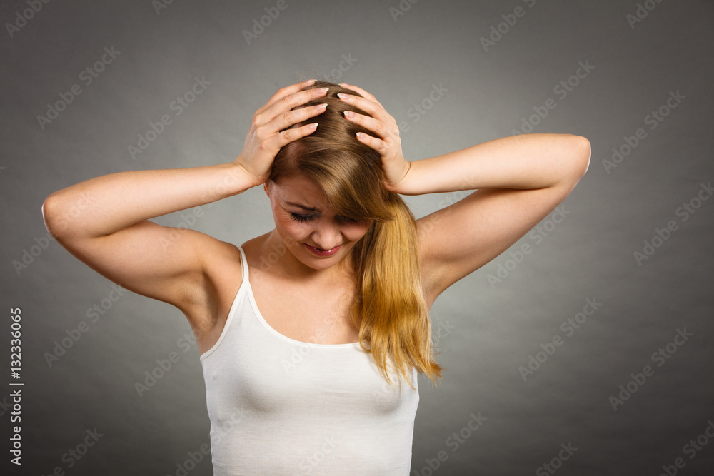 Woman suffering from headache migraine pain.