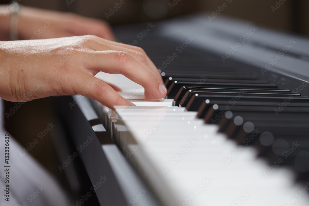 Fototapeta premium female's hands playing piano
