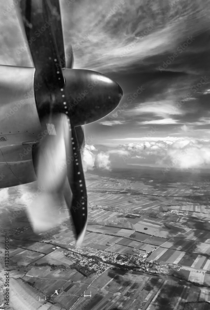 Black and white vertical view of an airplane propeller in flight with ...