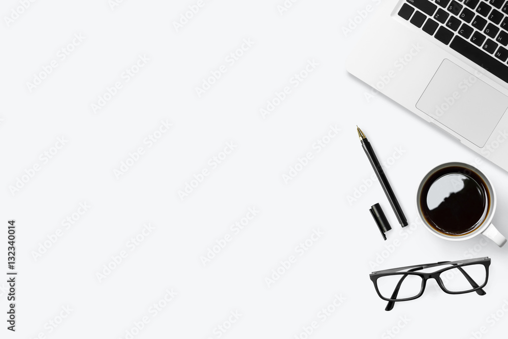 Modern white office desk table with laptop, coffee and supplies. Top view with copy space, flat lay.