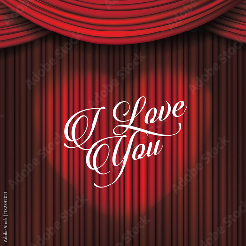 I love you written in a heart-shaped light on dramatic red curtains. Greeting card for your Valentine. Message of love for February 14th. 