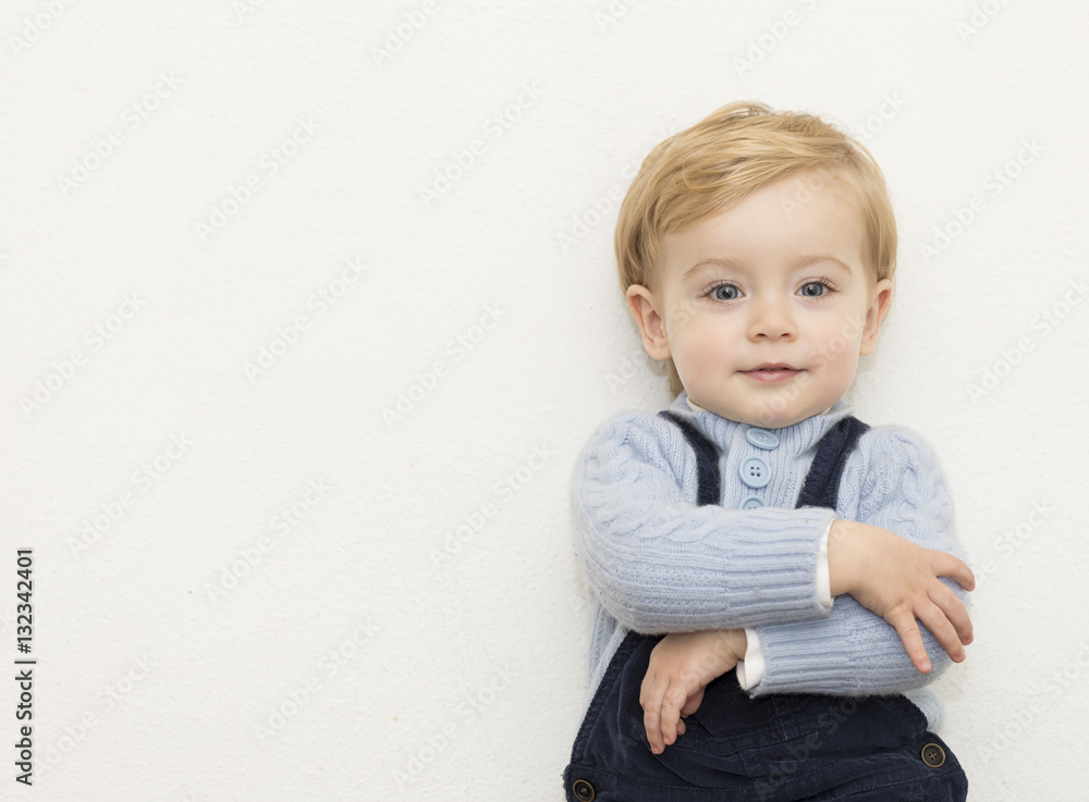 Sweet little kid standing with arms crossed over white backgroun Sweet little kid standing with arms crossed over white backgroun