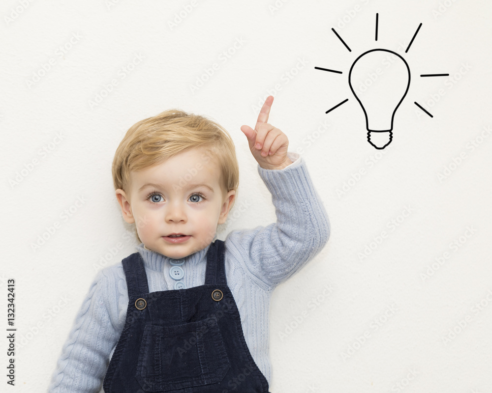 Cheerful smiling child pointing up on white background Cheerful smiling child pointing up on white background