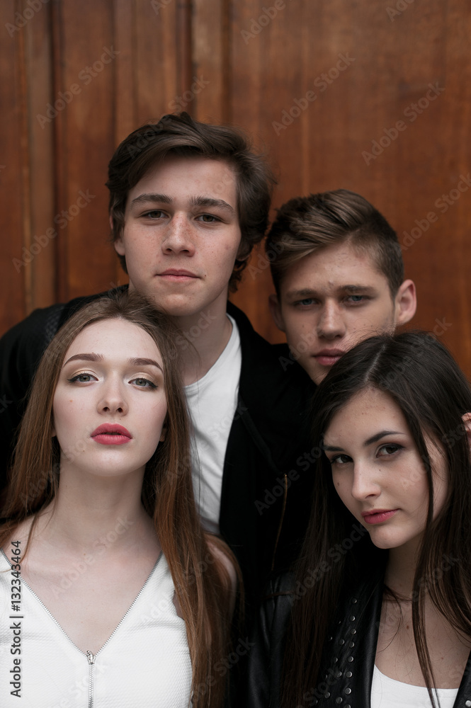 Fototapeta premium Young elegant trendy friends outdoors, wearing black and white clothing