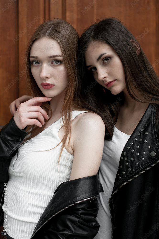 Young elegant trendy girls outdoors, wearing black and white clothing Young elegant trendy girls outdoors, wearing black and white clothing