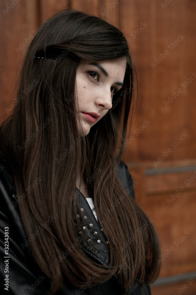 Fototapeta premium Young elegant trendy lady outdoors, wearing black and white clothing