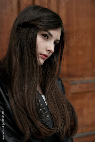 Young elegant trendy lady outdoors, wearing black and white clothing