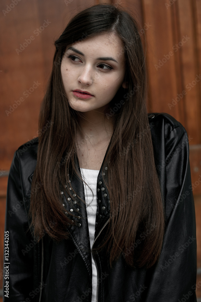 Fototapeta premium Young elegant trendy lady outdoors, wearing black and white clothing