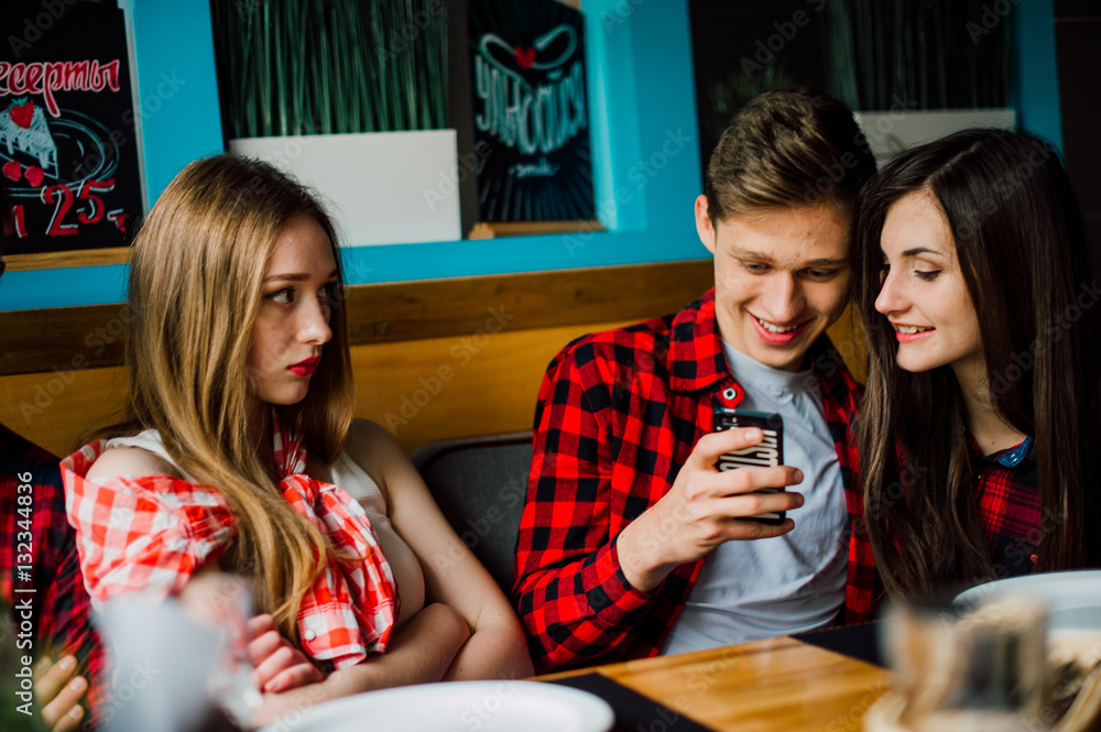 Group of young friends hanging out at a coffee shop. Young men and women meeting in a cafe having fun and drinking coffee. Lifestyle, friendship and urban life concepts. Group of young friends hanging out at a coffee shop. Young men and women meeting in a cafe having fun and drinking coffee. Lifestyle, friendship and urban life concepts.
