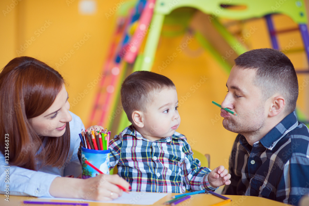 Young happy family with toddler boy playing together at home Young happy family with toddler boy playing together at home