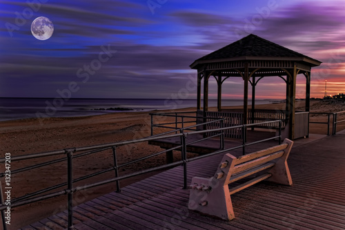 Moon over boardwalk by the sea © Harold Stiver