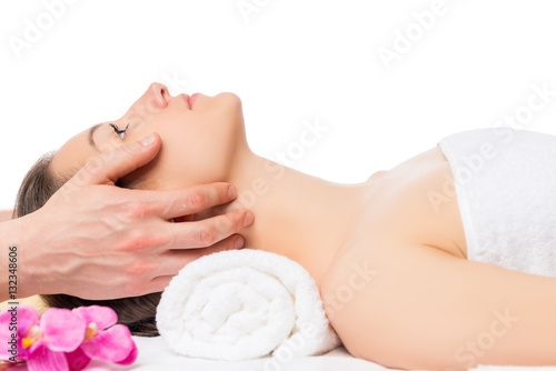 Horizontal portrait of a woman lying on a massage table isolated