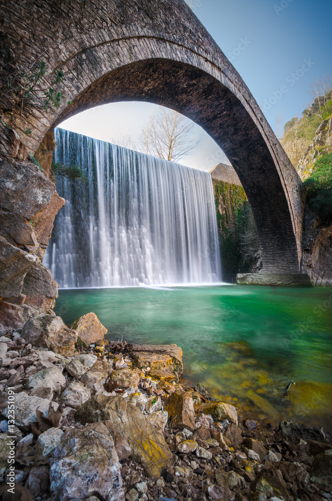 Paleokarya, old, stone, arched bridge, between two waterfalls. Trikala prefecture, Thessaly, Greece Paleokarya, old, stone, arched bridge, between two waterfalls. Trikala prefecture, Thessaly, Greece