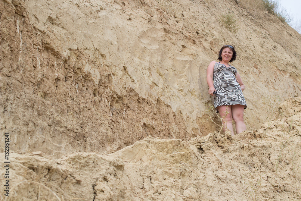 Fototapeta premium woman on mountain cliff