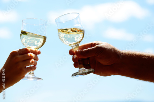 human hands with wine glasses