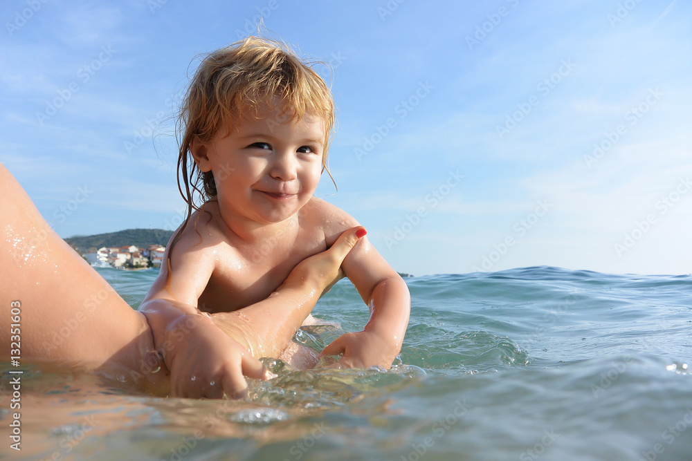 Cute little kid swims in water. Cute little kid swims in water.