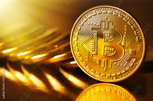 Golden Bitcoins on a gold background .Photo (new virtual money )