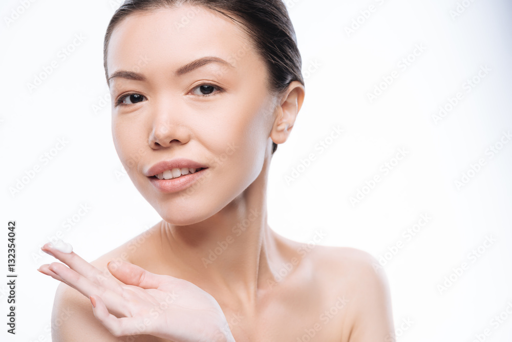 Cheerful nice woman preparing to apply facial cream Cheerful nice woman preparing to apply facial cream