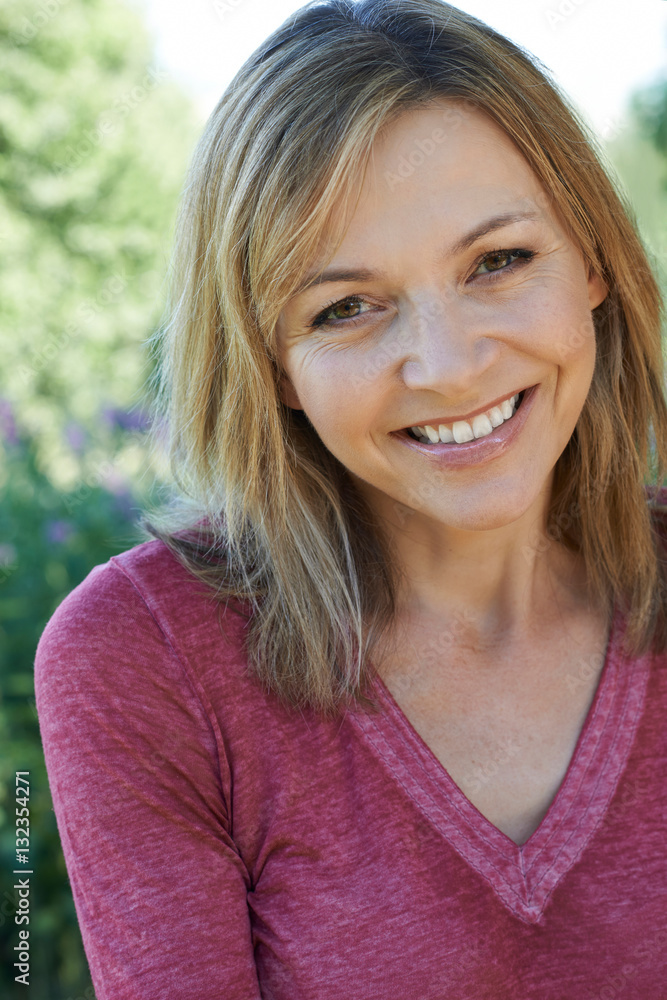 Outdoor Head And Shoulders Portrait Of Smiling Mature Woman Outdoor Head And Shoulders Portrait Of Smiling Mature Woman