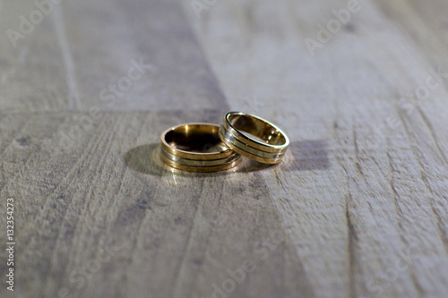 Golden rings on wooden background, Wedding rings