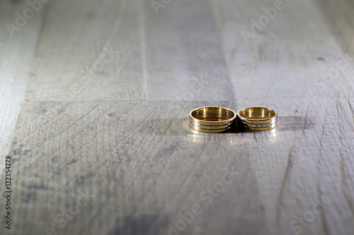 Golden rings on wooden background, Wedding rings