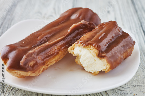 Homemade eclairs with cream and chocolate topping