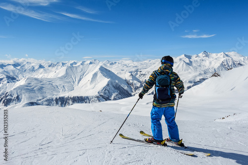 Skier standing in front of mountains